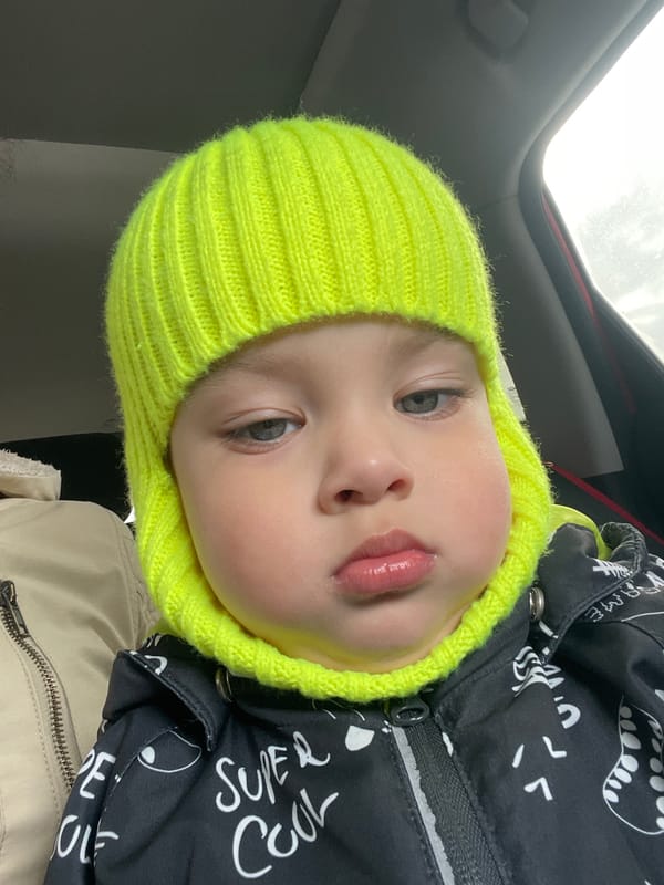 Baby in yellow hat photographed in Oktyabrsky, Russia