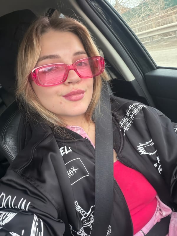 Woman in pink sunglasses spotted in car passenger seat