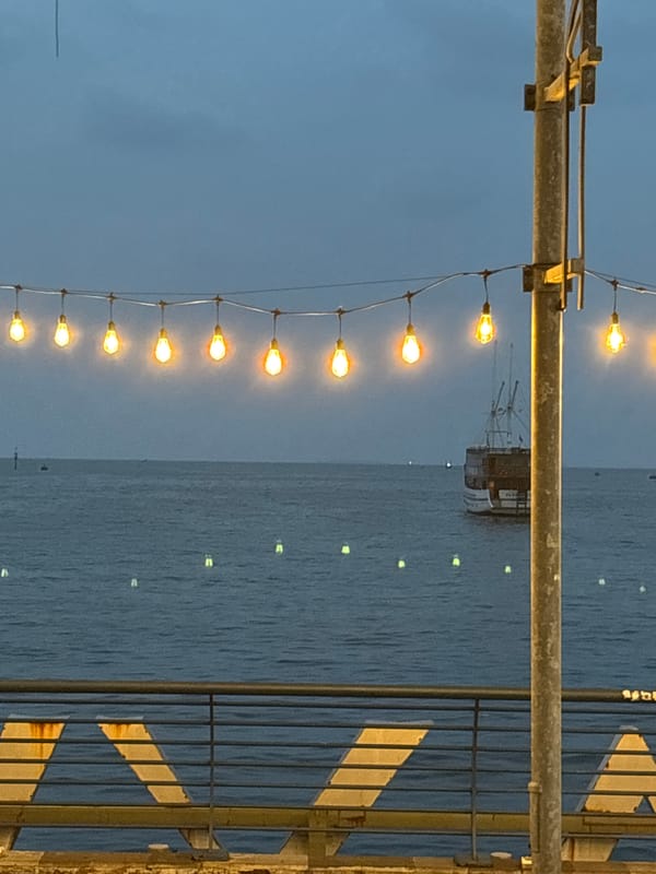 Evening stroll captured on illuminated Jakarta waterfront pier