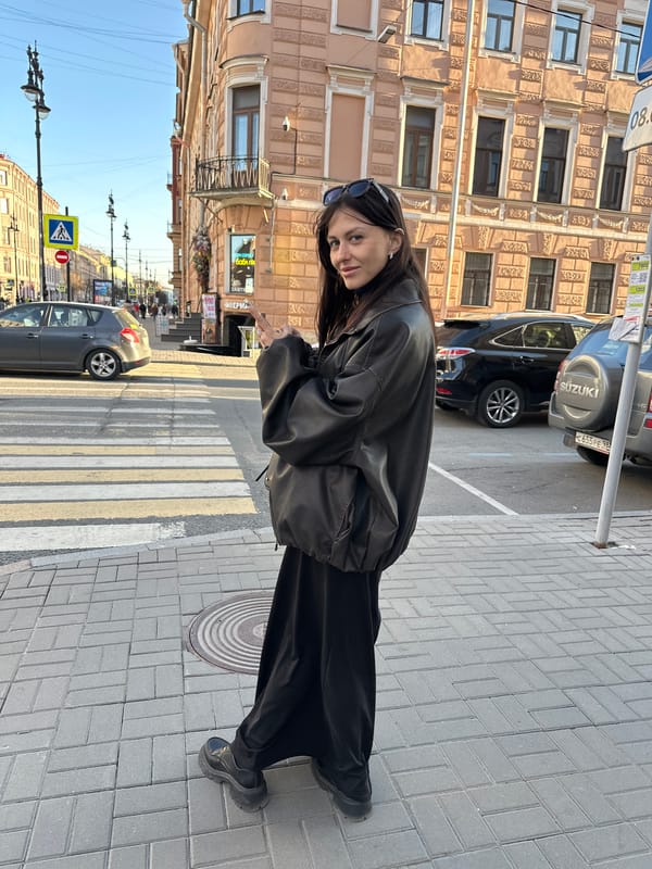 Woman photographed on Saint Petersburg sidewalk during sunny afternoon