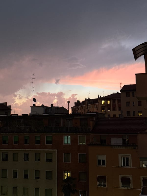 Dramatic sunset illuminates rainy Milan evening across multiple neighborhoods