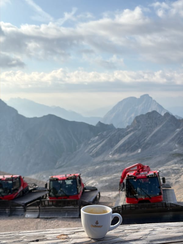 Construction crew and snowcats at work high in the Bavarian Alps