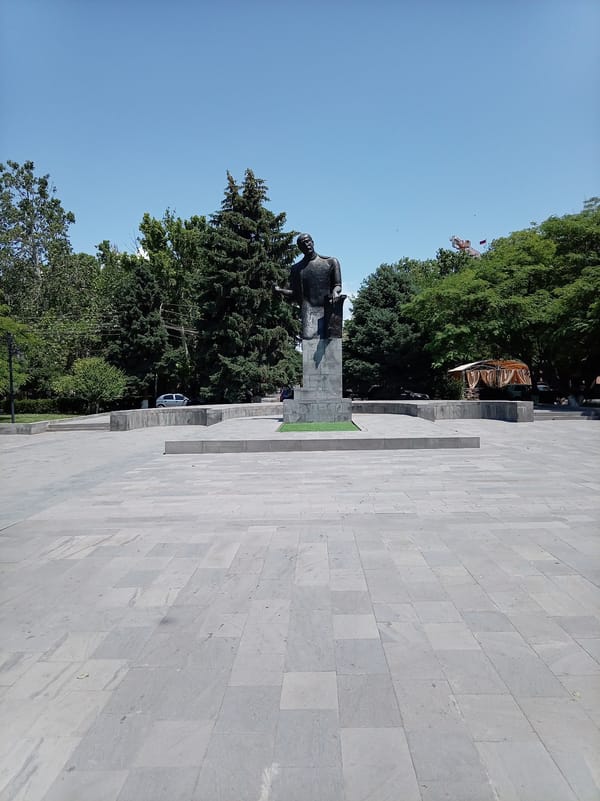 City park features bronze statue and colorful playground equipment