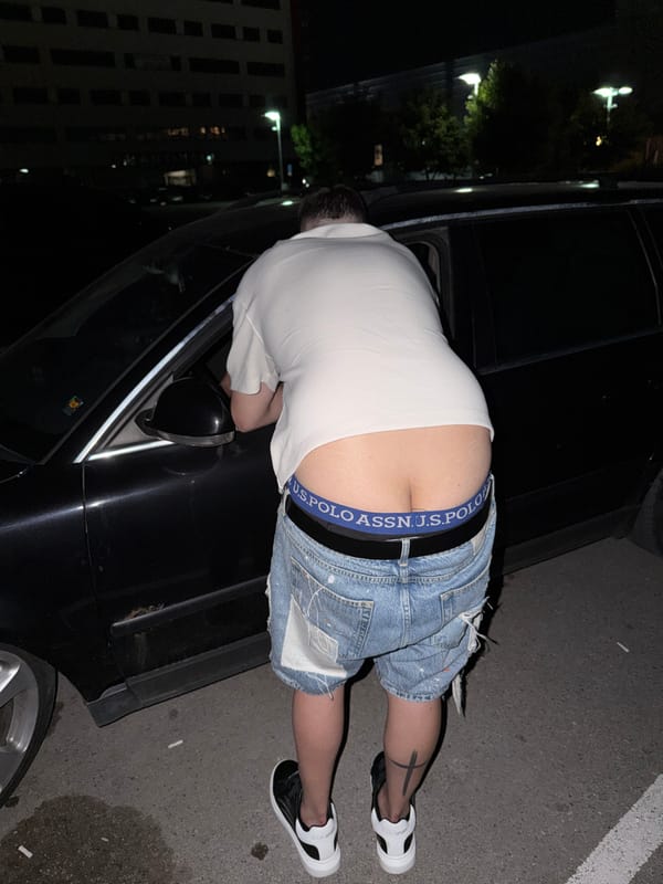 Young adults socialize in parking lot during evening gathering