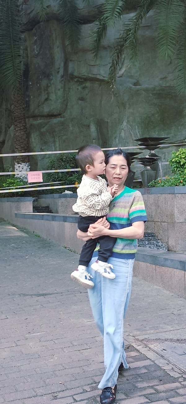Mother and child walk tree-lined sidewalk in Jiulongpo District