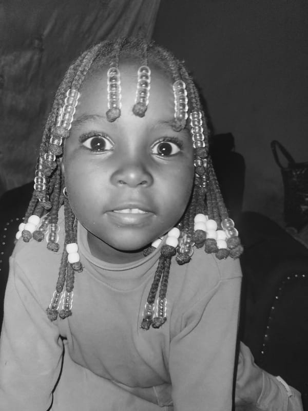 Portrait photograph captures young girl with beaded braids