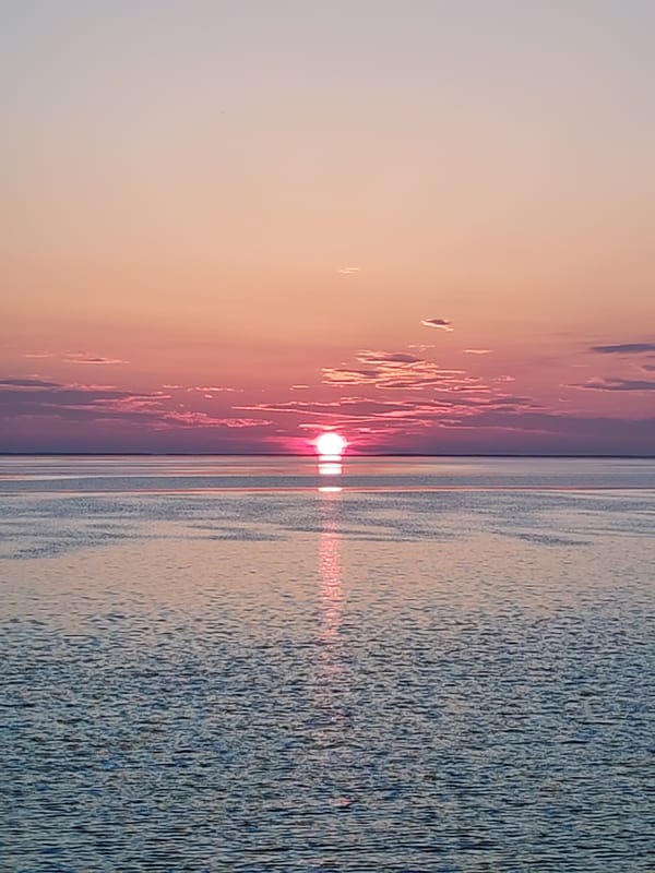 Sunset observed from vessel deck at sea