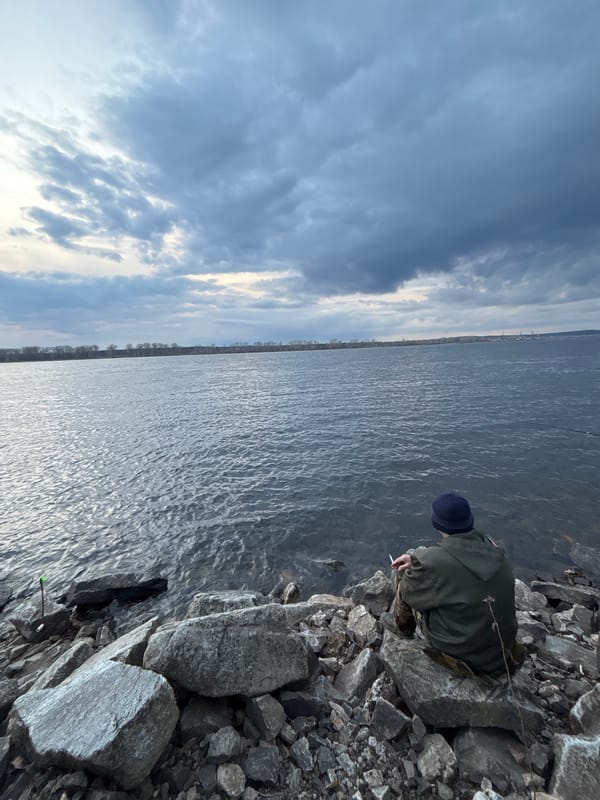 Person spends quiet afternoon by river in Chaikovsky, Russia