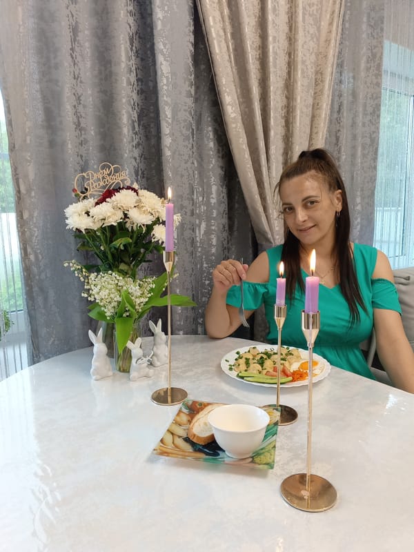 Woman enjoys festive meal with decorative table setting in Andreyevo