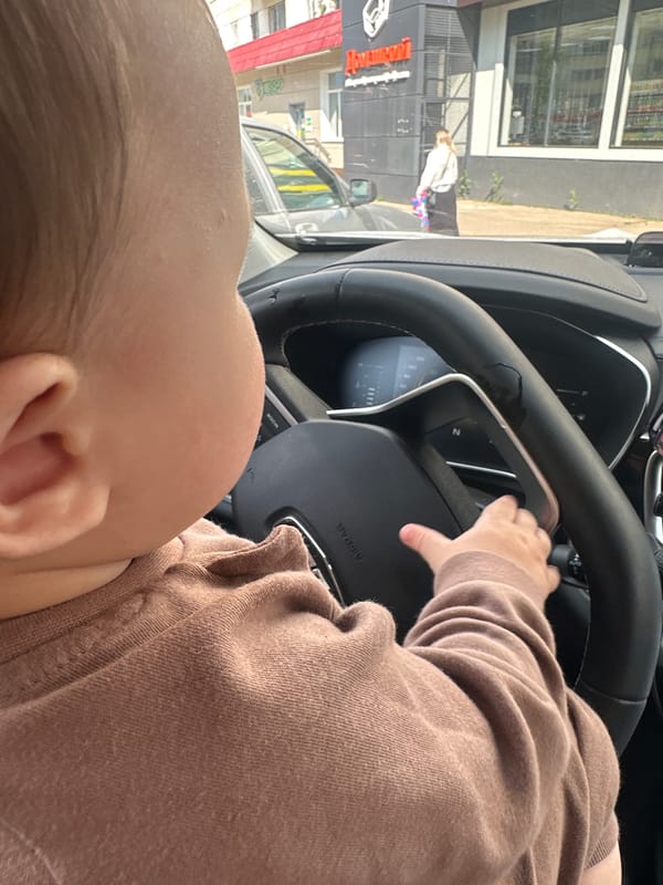 Family car trip with pop-it toys and steering wheel exploration