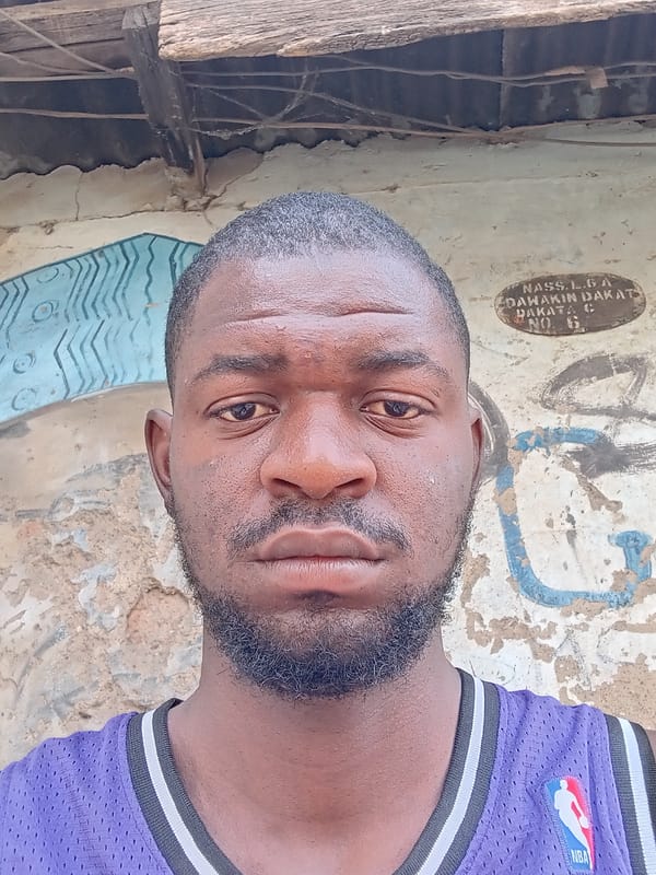 Person spotted on unpaved ground in Dakata, Nigeria