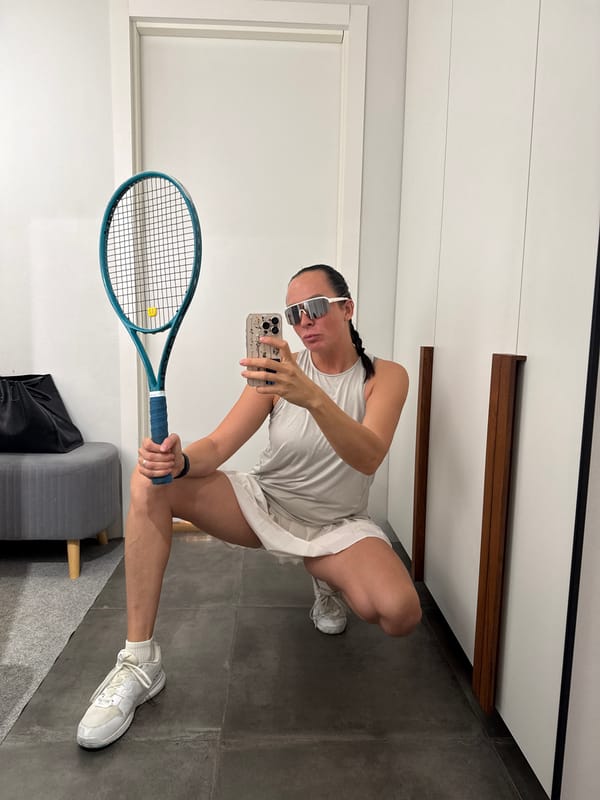 Heading out for tennis in Chaikovsky, racket in hand