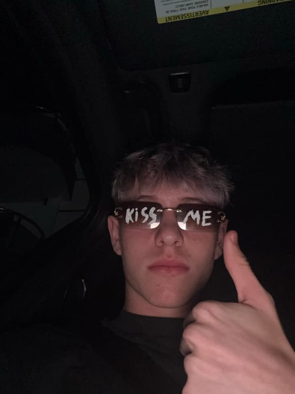 Thumbs up and 'KISS ME' shades in a parked car, Bulgaria