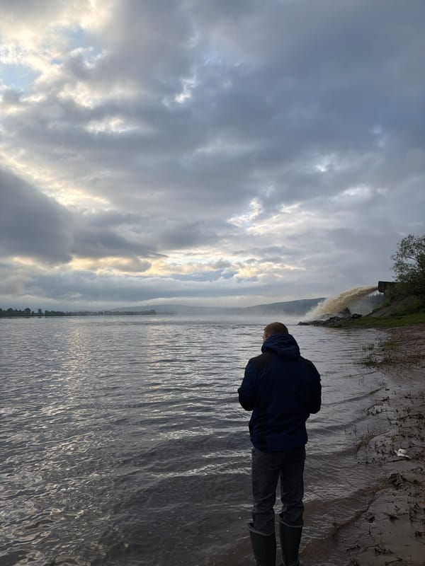 Person observed at water's edge in rural Russia