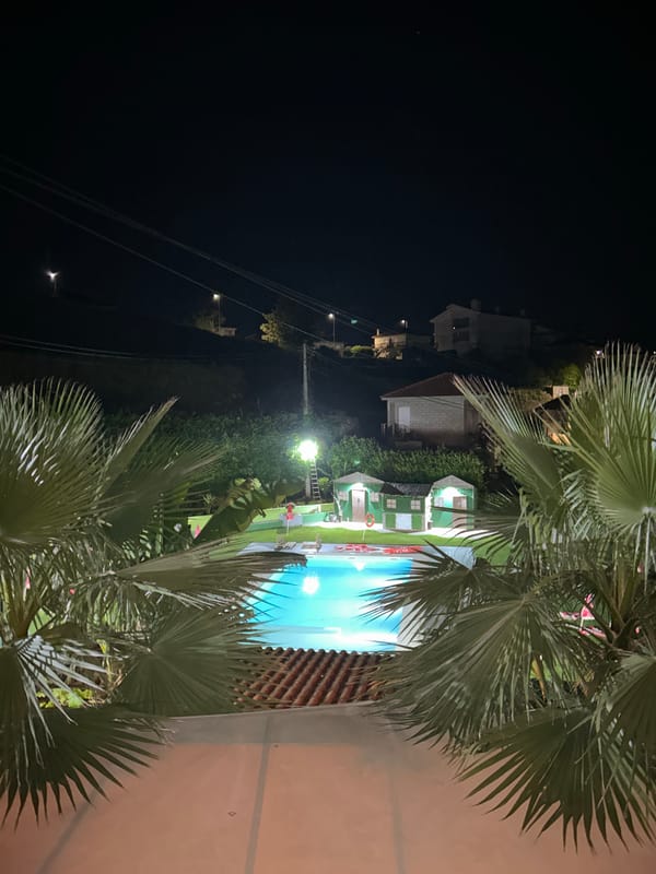 Nighttime swimming pool scene captured in Amarante, Portugal