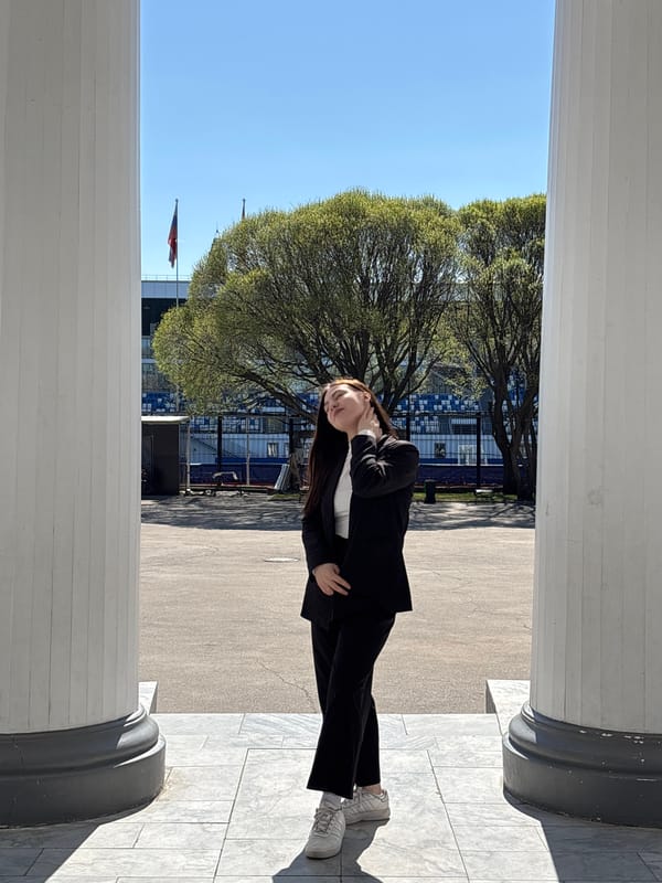 Woman in business suit photographed at marble columns in Perm