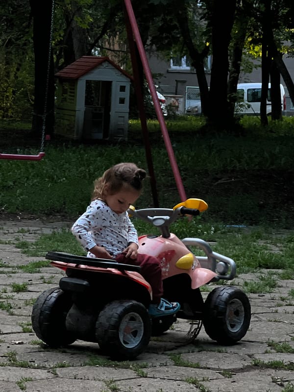 Child plays on toy vehicles in Sofia park