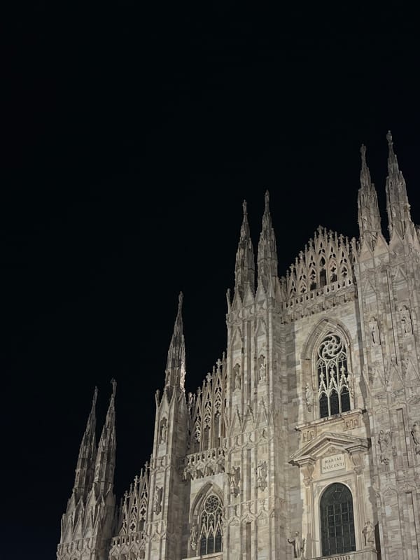Milan Cathedral at night, with street-level details nearby