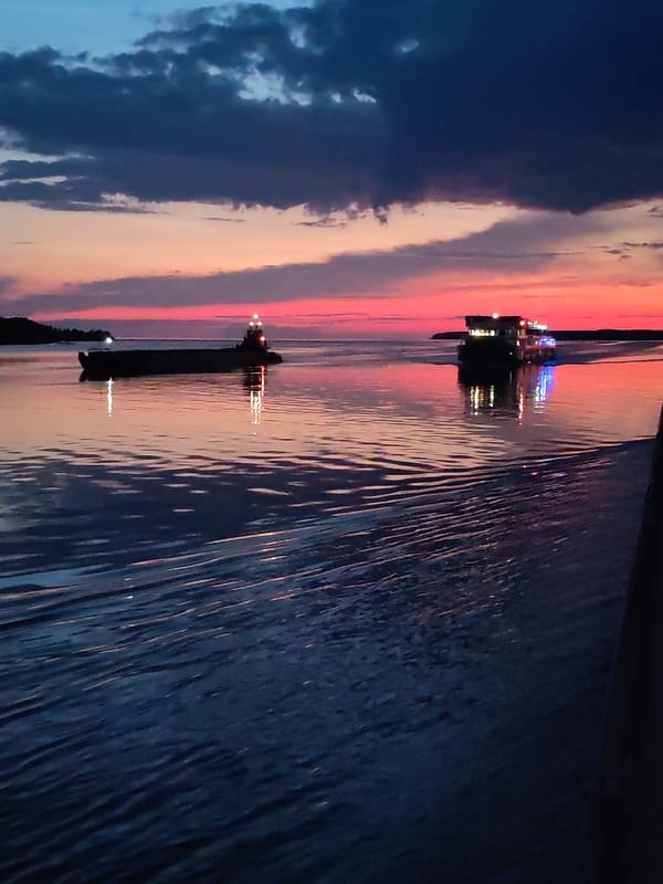 Barge at dusk on a Russian waterway, twilight sky glowing