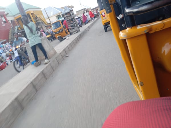 Riding through Jalingo's streets in a yellow tuk-tuk