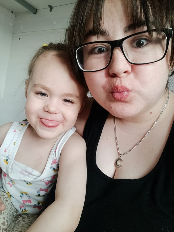 Mother and child share playful moments with flowers in Noviy