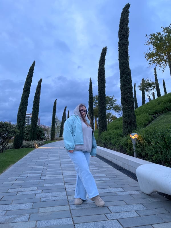 Woman photographed at modern Krasnodar park complex at twilight