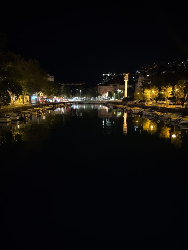 Rijeka harbor at night, boats moored along the waterfront