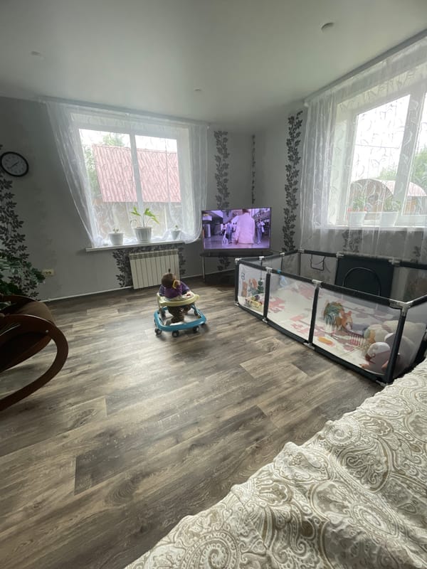 Lazy morning at home — baby in walker, pajamas, couch
