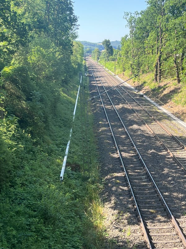Grader parked near railway corridor in rural Neustadt