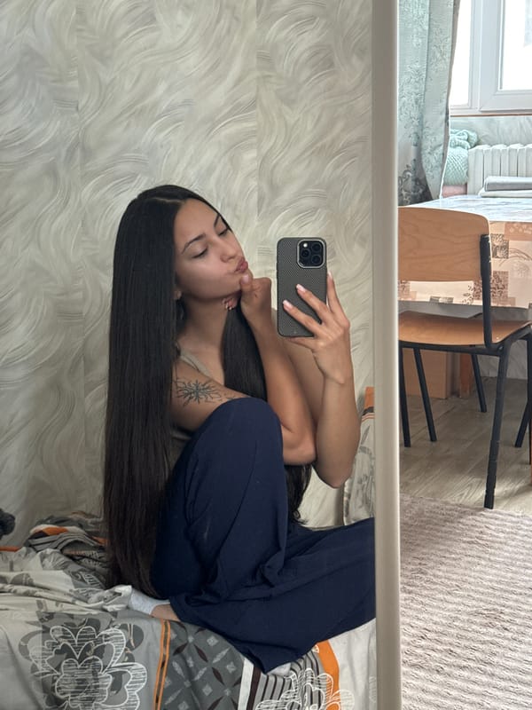Woman takes early morning selfies in Sofia bedroom