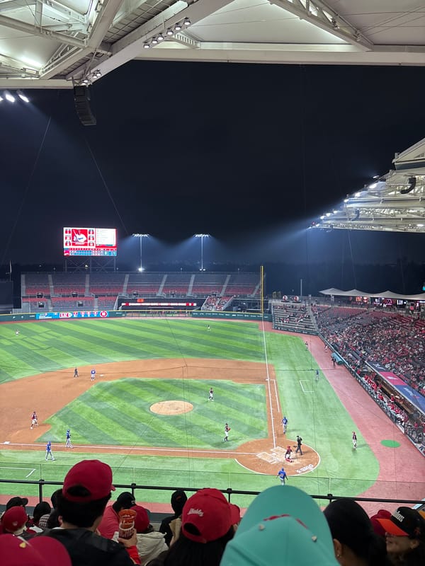 Night baseball and lit-up landmarks in Mexico City