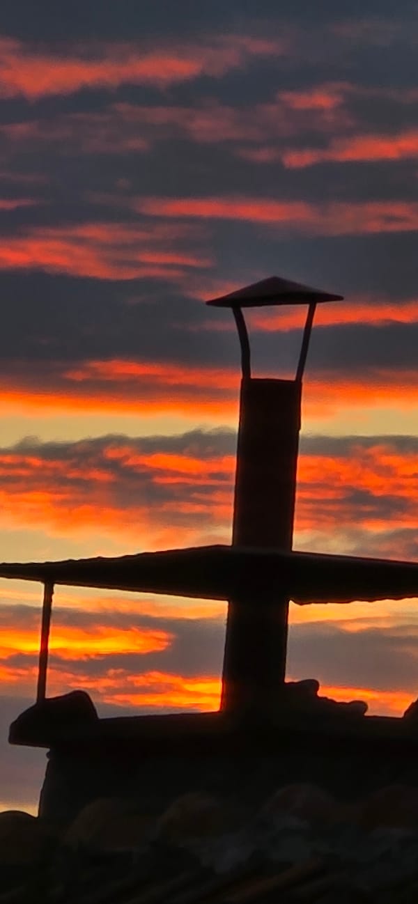 Silhouettes and warm sky over Marchaevo at golden hour