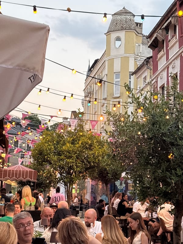 Cocktails and cobblestones at a European street restaurant after dark