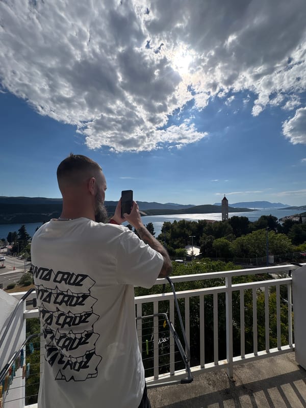 Tourist photographs coastal scenery from balcony in Neum