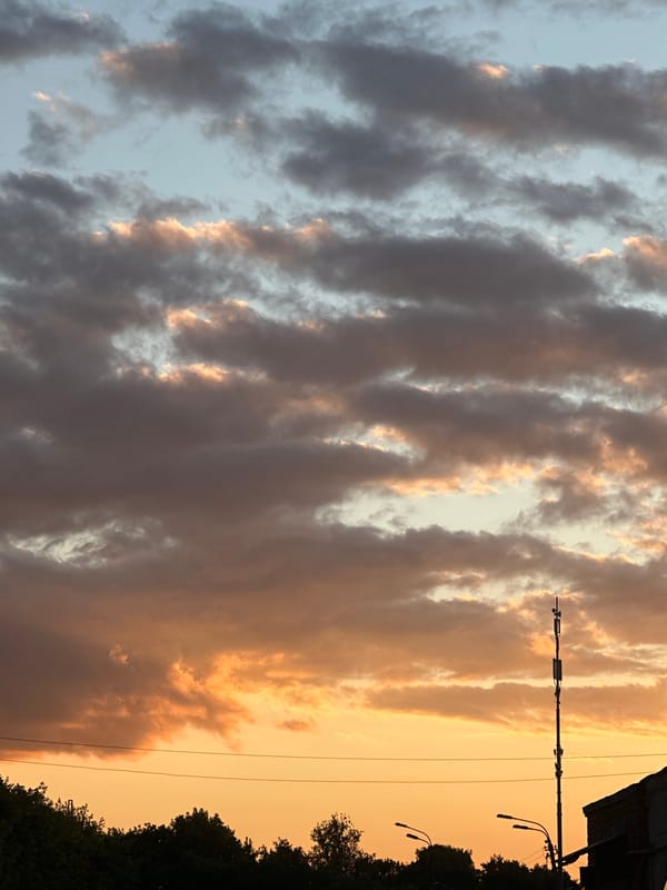 Kolomna garage district glows under a dramatic summer sunset