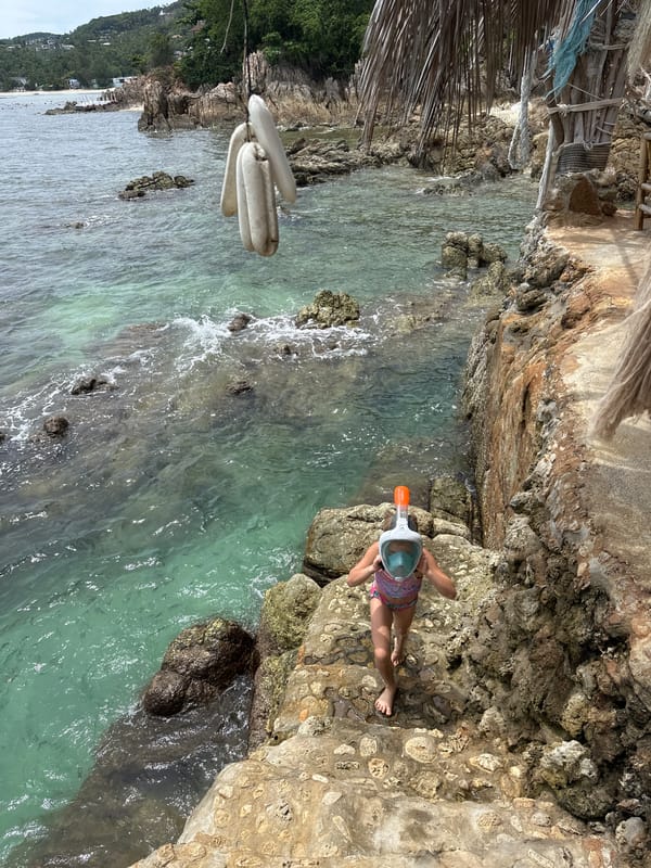 Koh Phangan beachside spot: nets, bronze sculptures, and snorkeling