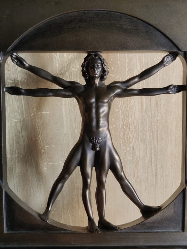 Succulents, a curious cat, and a bronze Vitruvian Man
