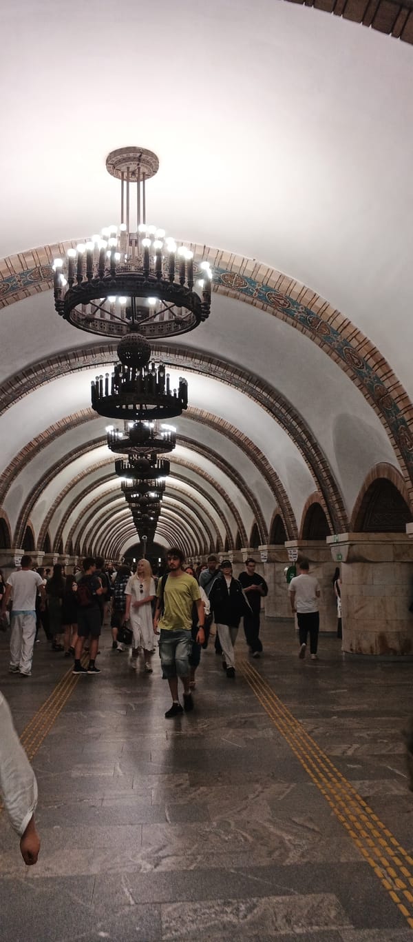 Exploring a grand subway station with ornate mosaics and chandeliers