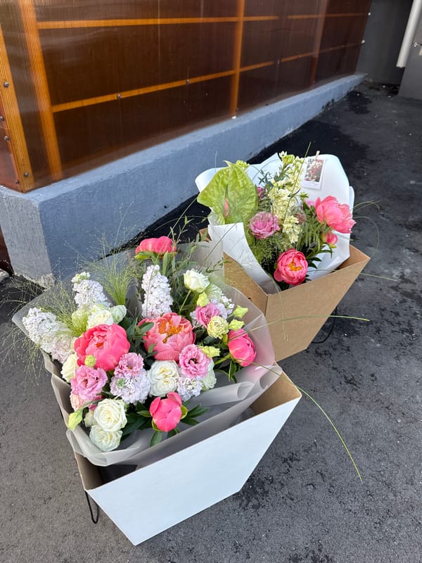 Child explores flowers, woman takes selfies in Izhevsk afternoon