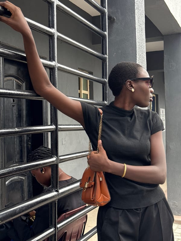 Woman in black observed at gate in Ojomu, Nigeria