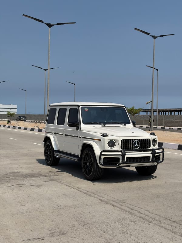 White vehicles parked on modern streets in Alaguntan, Nigeria