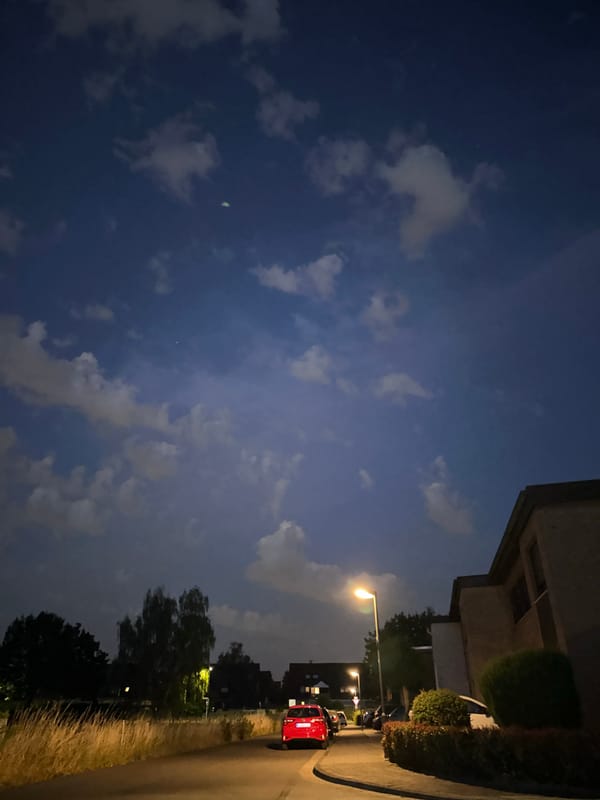 Krefeld suburban streets at dusk, streetlights on, traffic passing
