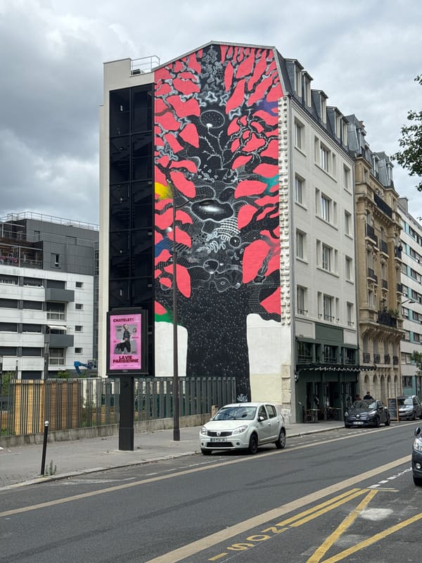 Large black and red mural spotted on urban building