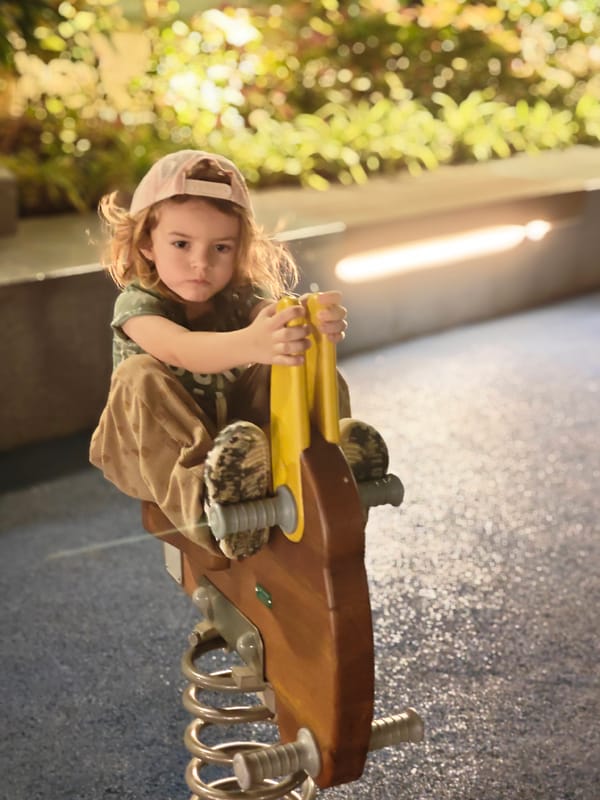 Child plays at Mumbai playground during evening hours