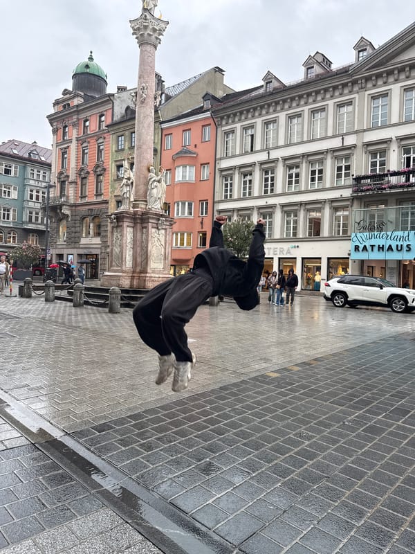 Street performer executes flips in rainy Innsbruck square