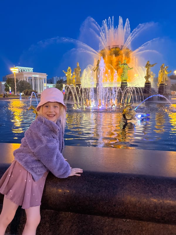 Evening visitors enjoy illuminated fountain at Moscow's VDNKh complex