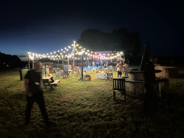 Nighttime outdoor gathering with dancing in Tewkesbury