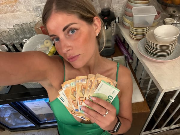 Euro cash fanned out near a Paris café register