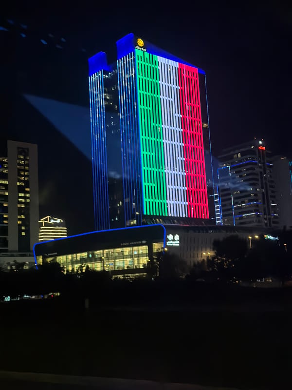 Lusail skyscraper displays illuminated Qatar flag at night