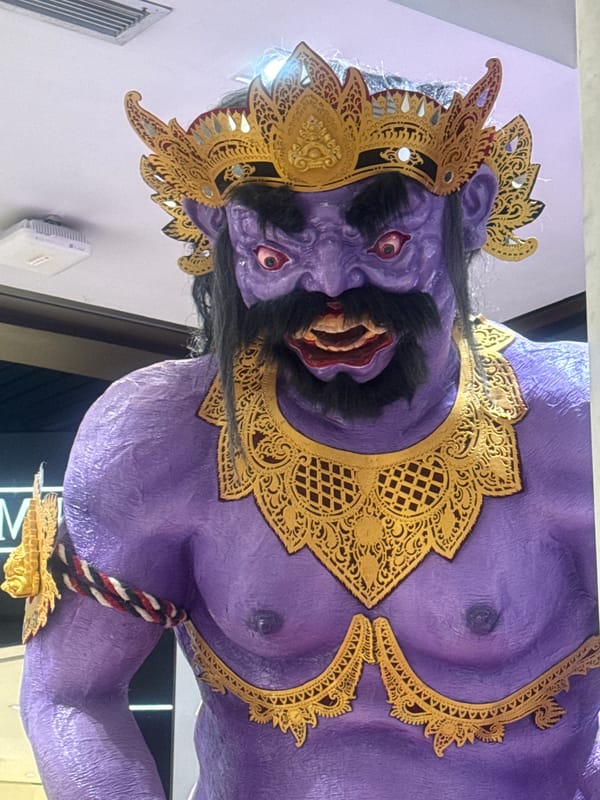 Traditional Balinese masks and statues displayed in Kuta commercial space